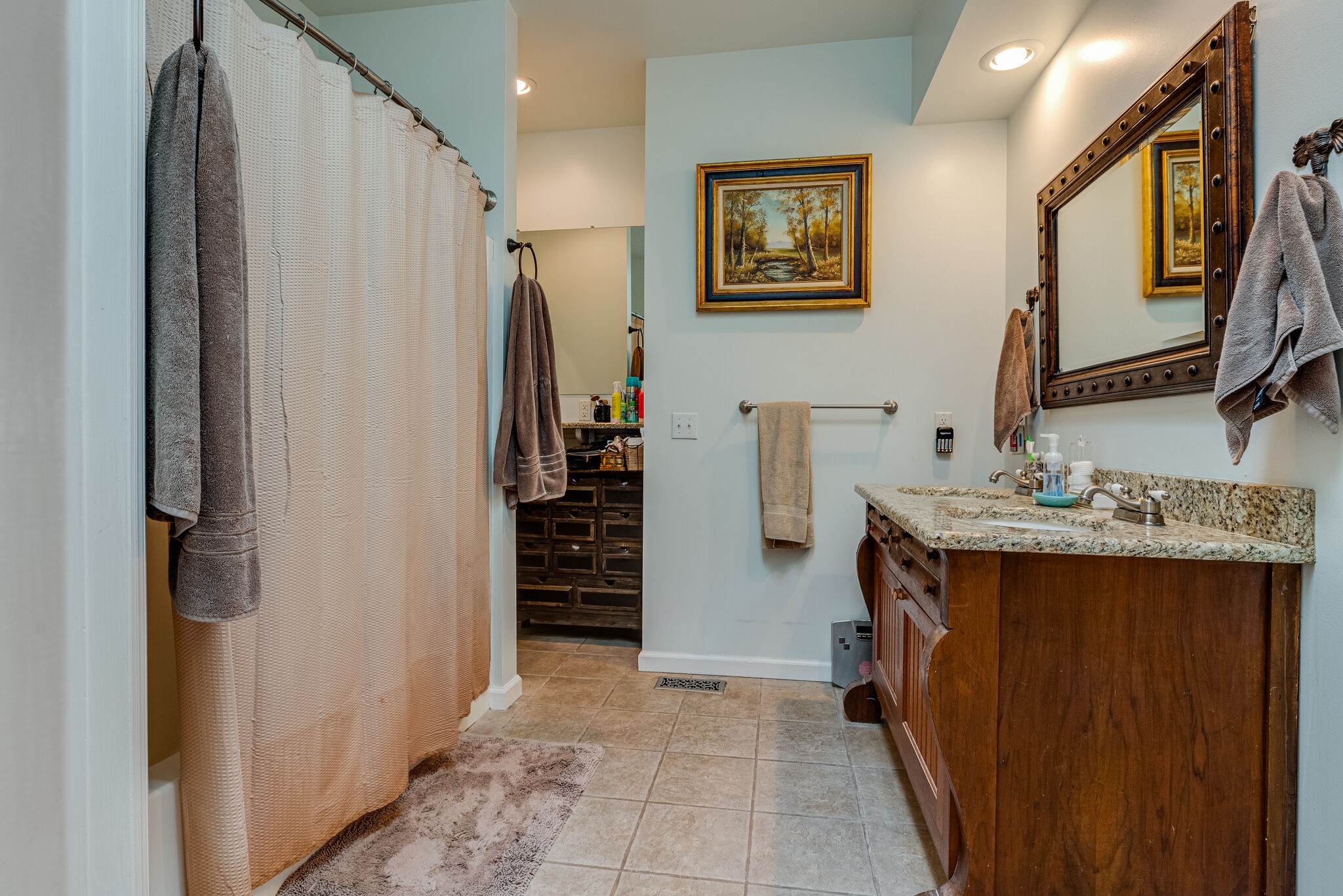 Master Bath presents a tiled floor, a spacious walk-in closet, inviting granite double vanities, and a dedicated make-up area.
